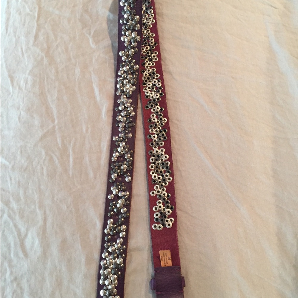 Purple, leather cowboy belt with silver rivets.